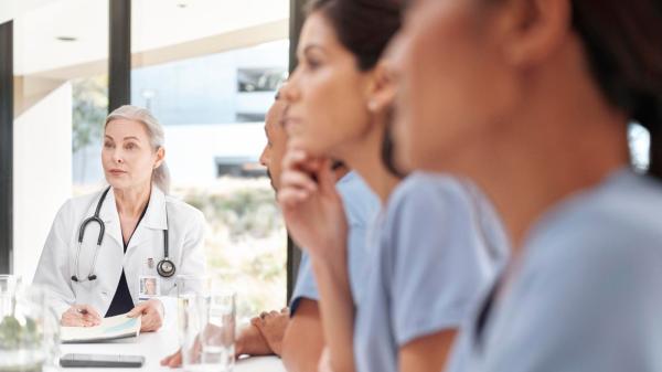 Clinicians review a healthcare business case in a meeting