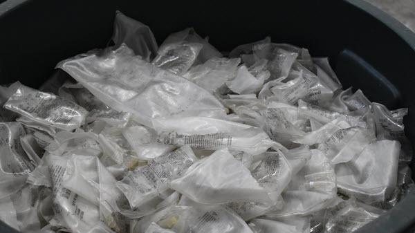 Recycling container full of IV Solution bags