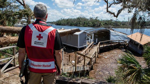 Red Cross volunteer surveys storm damage